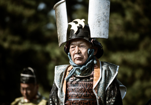 Kyoto, Japan - October 22, 2012: Samurai warrior at the Jidai Matsuri festival. Also called the Festival of Ages it is a traditional festival celebrated every 22 of October since 1895 to commemorate the  anniversary of the foundation of Kyoto. It is a large parade with over two thousand people dressed in accurate costumes of the japanese history that spans 1100 years when Kyoto was Japan capital and also represents well important historic figures of the past. The parade goes from the Imperial Palace to the Heian Shrine.