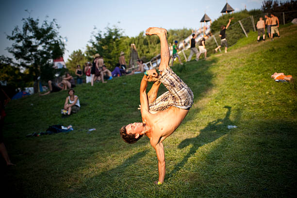 handstand woman in a sunset mountain top grassland meadow