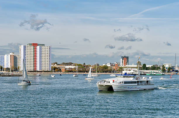 Portsmouth, UK. 16th February 2017. A view of Portsmouth Harbour towards Portsmouth Harbour station with the tall masts of HMS Victory visble.