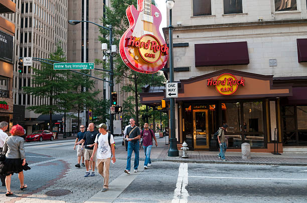 Atlanta, GA, USA - August 3, 2011: Pedestrians cross the street outside a Hard Rock Cafe in downtown Atlanta, Georgia
