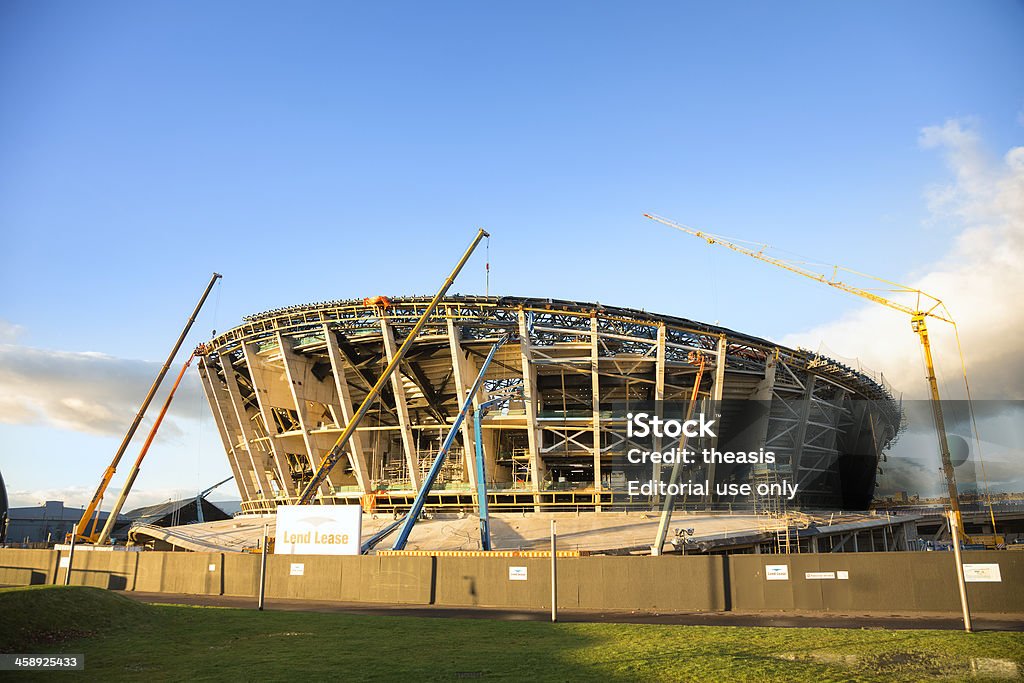 Construction of the Scottish Hydro Arena, Glasgow "Glasgow, UK - December 7, 2012: The construction site of the Scottish Hydro Arena on the River Clyde in Glasgow as construction workers work in the evening light. Designed by Fosters and Partners, and being constructed by Bovis Lend Lease, the new arena will be part of the Scottish Exhibition and Conference Centre. It is scheduled to open in 2013 and to be used as a stadium for the Commonwealth Games in 2014." Adult Stock Photo