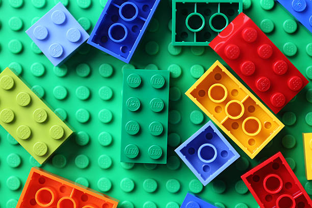LEGO Blocks on green baseplate "Tambov, Russian Federation - June 22, 2012: LEGO Blocks on a green baseplate. Lego toys manufactured by the Lego Group (Billund, Denmark)." lego stock pictures, royalty-free photos & images