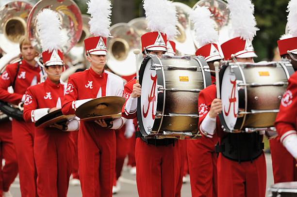 Million dollar band drum section Tuscaloosa, Alabama, USA - October 27, 2012: Drummers and percussion section marching in The Million Dollar Band during the 2012 University of Alabama homecoming day parade in Tuscaloosa. Taken near stadium on University Boulevard. bass drum photos stock pictures, royalty-free photos & images
