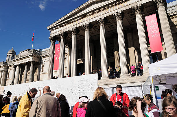 London, England- May 6, 2024: Trafalgar Square and the The National Gallery under cloudy sky.