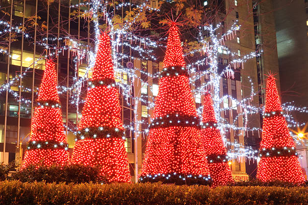 New York City: Christmas "New York City, United States - December 4, 2012: Decorated Christmas Trees before News Corporation" times square new years eve stock pictures, royalty-free photos & images