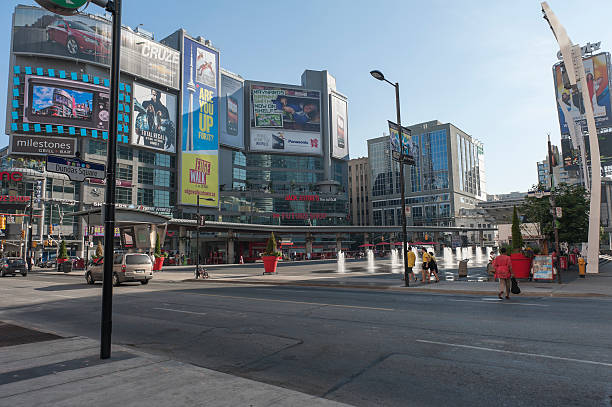 Dundas square in downtown Toronto on a sunny summer day "Toronto, Canada - July 30, 2012: dundas square in downtown Toronto on a sunny summer day with lots of people hanging around, sitting and walking" toronto dundas square stock pictures, royalty-free photos & images