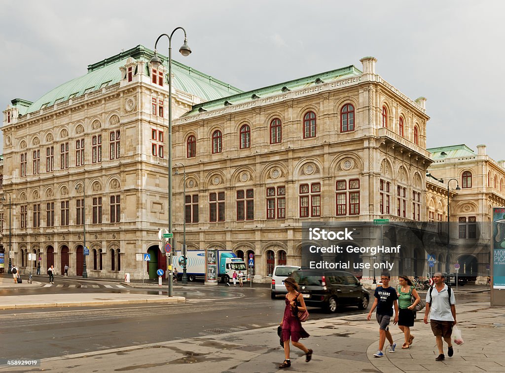 National Opera of Vienna "Vienna, Austria - July 6, 2012: Look at the back of the State Opera in Vienna, from the terrace of the Albertina seen. In the photo cars and many people can be seen and moving across the street. The sky over the opera's cloudy and gray." Architecture Stock Photo