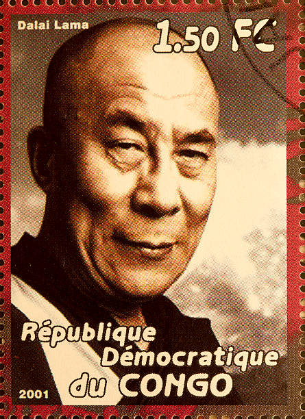 Dalai Lama "Newcastle, United Kingdom - September 18, 2012: Dalai Lama featured on a stamp from The Republique du Congo in 2001" dalai lama stock pictures, royalty-free photos & images