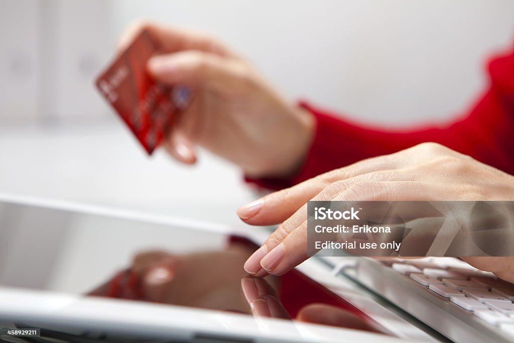 Shopping in iPad Nizhnevartovsk, Russia - November 29, 2012: Close-up hands woman using iPad and holding credit card. Keyboard and iPad 3 product by Apple Inc. Adult Stock Photo