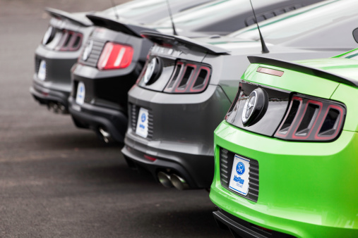 Dartmouth, Nova Scotia, Canada - October 28, 2012: At a car dealership, numerous colors of Ford Mustangs in a row.  Models include both Mustang GT and 2013 Shelby GT500 which feature the quad-exhausts.