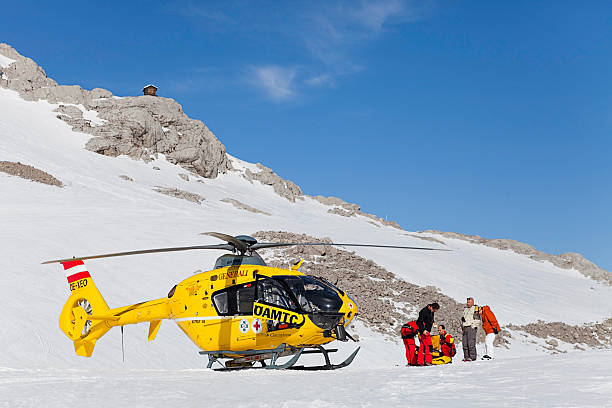 Rescue helicopter "Ramsau am Dachstein, Austria - March 21, 2012: Rescue helicopter and paramedics arrived after ski accident" dachstein mountains photos stock pictures, royalty-free photos & images