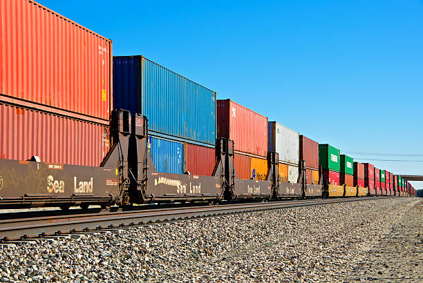 Railroad train freight container carriers, Palm Springs, California "Palm Springs, California, USA - January 13, 2012: A Union Pacific Railroad freight train loaded with overseas shipping containers is seen moving westward near Palm Springs, Coachella Valley, Western USA." coachella valley photos stock pictures, royalty-free photos & images
