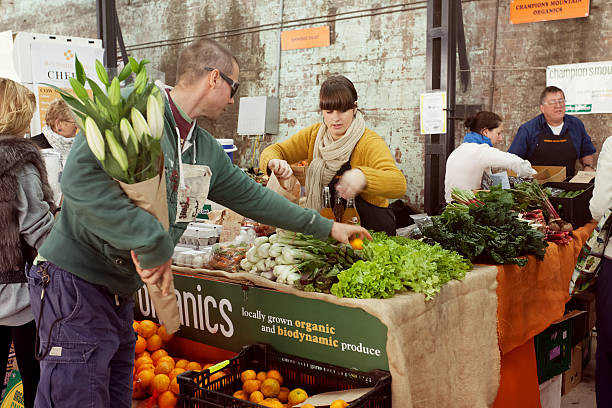 Farmer's market "Sydney, NSW, Australia - May 25, 2012. People shopping at a farmer's market in Sydney. The location is Carriageworks. The shop is selling organic food." retain stock pictures, royalty-free photos & images