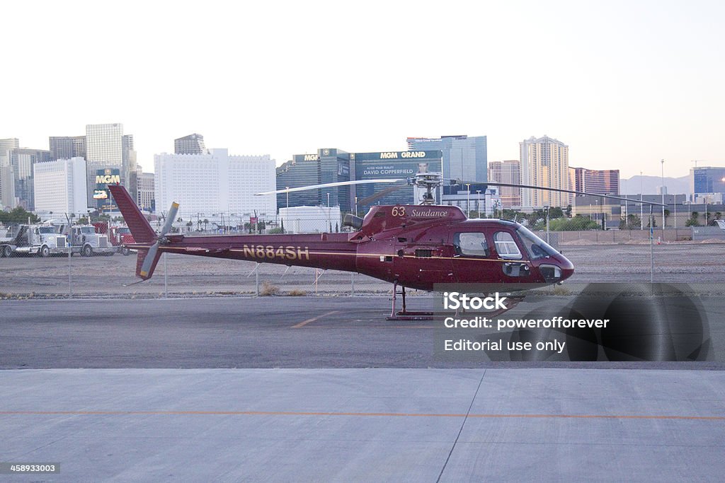 Aerial Tour of Las Vegas "Las Vegas, Nevada, United States - May 15, 2012. Helicopter at airport waiting to take off for aerial tour, Las Vegas Strip in  the background. Aerial tours of the strip and surrounding area are popular with tourists in Las Vegas." Helicopter Stock Photo