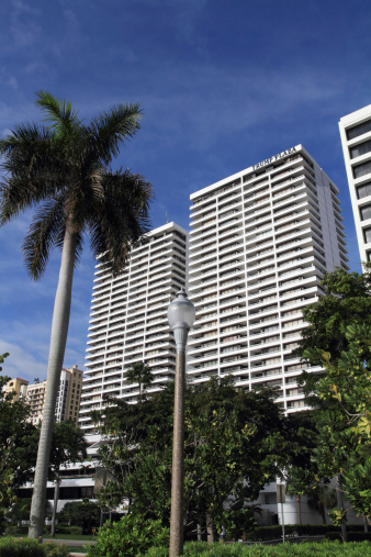 Honolulu, Oahu, Hawaii, USA: Prince Kuhio Federal Building & U.S. Courthouse on the harbor waterfront - brutalist architecture on Ala Moana Blvd, designed by Joseph G.F. Farrell's firm Architects Hawaii - official seat of the United States federal government and its local branches of various agencies and departments in the state of Hawaiʻi - It houses the US District Court for the District of Hawaii, the US Attorney for the District of Hawaii, the US Court of Appeals for the Ninth Circuit, the offices of Hawaii's U.S. Senators, the offices of Hawaii's U.S. Representatives for Hawaii's 1st and 2nd congressional districts, and branch offices of the US Secret Service, US Probation and Pretrial Services System, Department of Homeland Security, US Department of Justice, Central Intelligence Agency (CIA), Federal Bureau of Investigation (FBI), Internal Revenue Service (IRS), Department of Veterans Affairs, etc - Keauhou Place in the background.