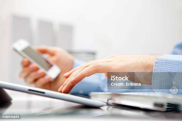 Man Using Ipad And Iphone Stock Photo - Download Image Now - Adult, Analyzing, Apple Computers