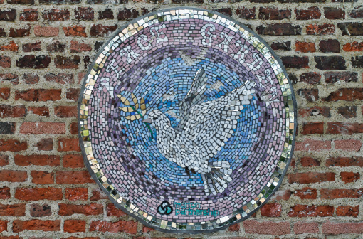 This mosaic plaque / wall mural is part of the Peace Garden in the Canons Recreation Ground, Mitcham in Merton, England. It was unveiled as part of Peace Week in 2009 during the Peace Garden naming ceremony. The Merton Partnership has three main aims: bringing together diverse communities to participate in varied activities; developing a greater understanding and respect of each other; and contributing to the quality of life of the people of Merton.