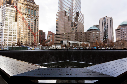 New York, United States - January 13, 2012: The World Trade Center memorial in Ground Zero New York. It will be part of the new World Trade Center complex with four more skyscrapers and a memorial to the September 11th attacks in 2001. The names of the 2977 victims of the attack on 2001 and also those killed on the 1993 attack are engraved in stone around the pools.
