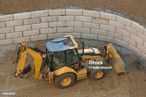 Caterpillar Backhoe Stock Photo - Download Image Now - Retaining Wall, Construction Industry, Construction Site