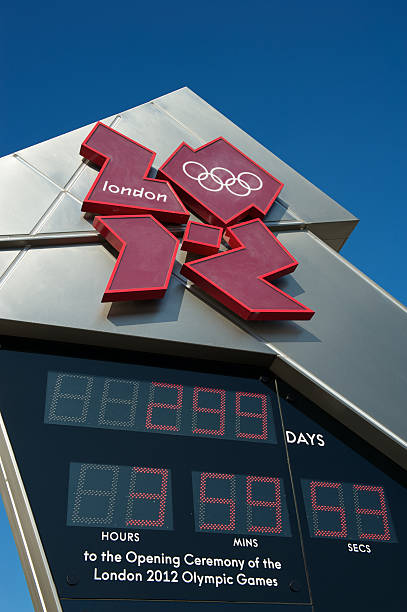 London 2012 Olympics Countdown Clock Blue Sky "London, UK - October 2, 2011: Metal sculpture features abstract logo and countdown clock for the London 2012 Olympic Games. The typeface and color were designed to convey a sense of energy." 2012 stock pictures, royalty-free photos & images