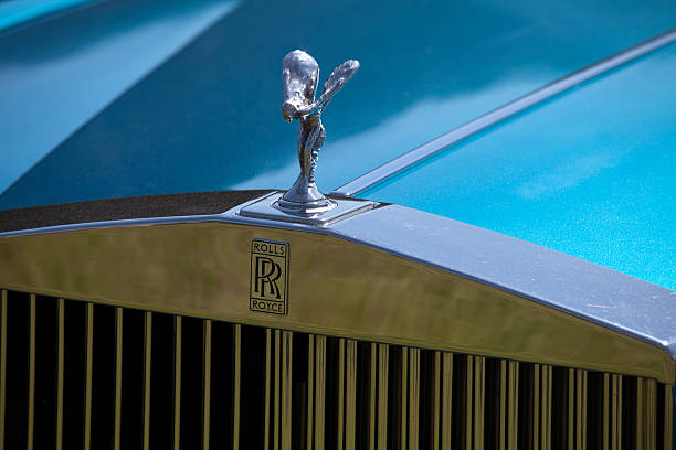 Spirit of Ecstasy Hood Ornament on a Rolls-Royce Car "Milton of Crathes, Scotland - May 27, 2012: Spirit of Ecstasy Hood Ornament on a Rolls-Royce Car parked at a classic car rally on Deeside.  The Spirit of Ecstasy was originally designed by Charles Robinson Sykes and was presented to the company in February 1911, being subsequently fitted to almost all Rolls-Royce luxury vehicles." rolls royce stock pictures, royalty-free photos & images