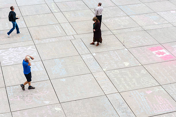Jack Layton's Chalk Memorial "Toronto, Canada - August 26, 2011: People viewing chalk messages outside City Hall in Toronto, as part of a public memorial to NDP leader Jack Layton after his death on August 22, 2011." ndp stock pictures, royalty-free photos & images