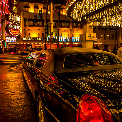 Las Vegas, USA - December 25, 2011 : A black limousine parked in front of the Golden Gate Hotel and casino in the Fremont area of Downtown Las Vegas. People visible in the scene.