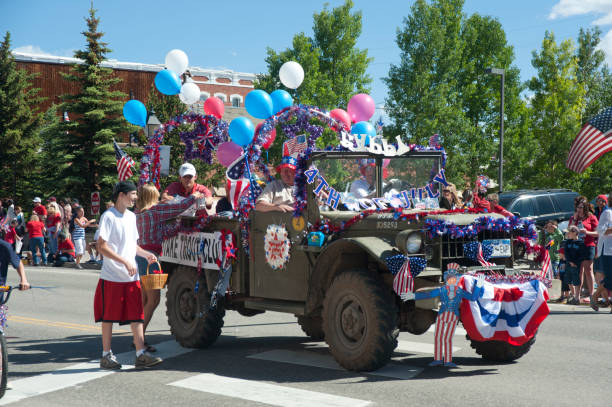 Fourth of July Parade Float "Leadville, United States - July 4, 2010: A Fourth of July parade float participant in Leadville, Colorado has decked an old jeep out with a multitude of American flags, banners and balloons in celebration of the holiday." leadville stock pictures, royalty-free photos & images