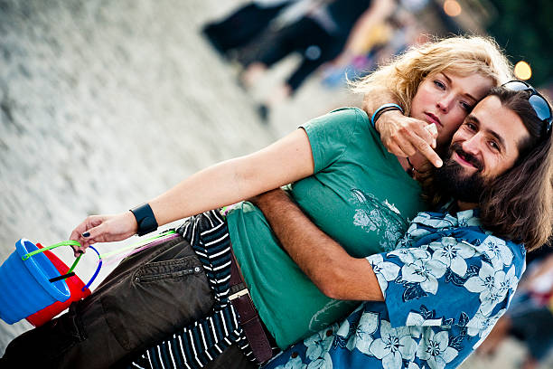 Venice, Italy - June 23, 2025: Young woman photographs couple embracing in a historic plaza, highlighting the beauty of love and shared memories