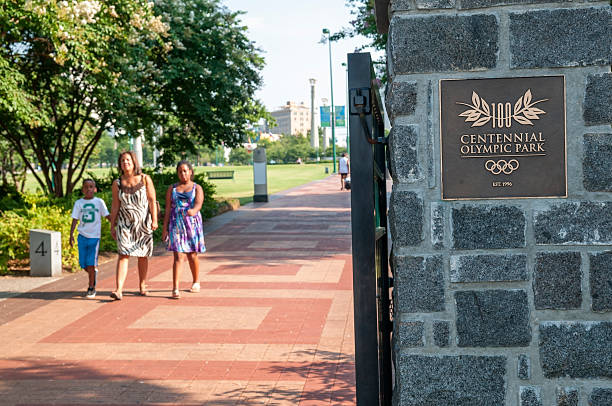 Atlanta, GA, USA - August 3, 2011: A woman and two children walk toward the exit of Centennial Olympic Park. The park was created for the 1996 Olympic Games and continues to be a popular green space downtown.