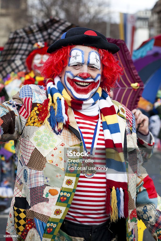 Rosenmontagszug, Street carnival on Rose Monday in Mainz, Germany "Mainz, Germany - February 20, 2012: The Rosenmontagszug (carnival parade) moves through the streets of Mainz, Germany. A colourful costumed participant walks down the street - waving and cheering and disguised as a clown. Rosenmontagszug in Mainz is one of the largest and most famous carnival parades in Germany with approx. 500.000 spectators. Some minor motion blur" Germany Stock Photo