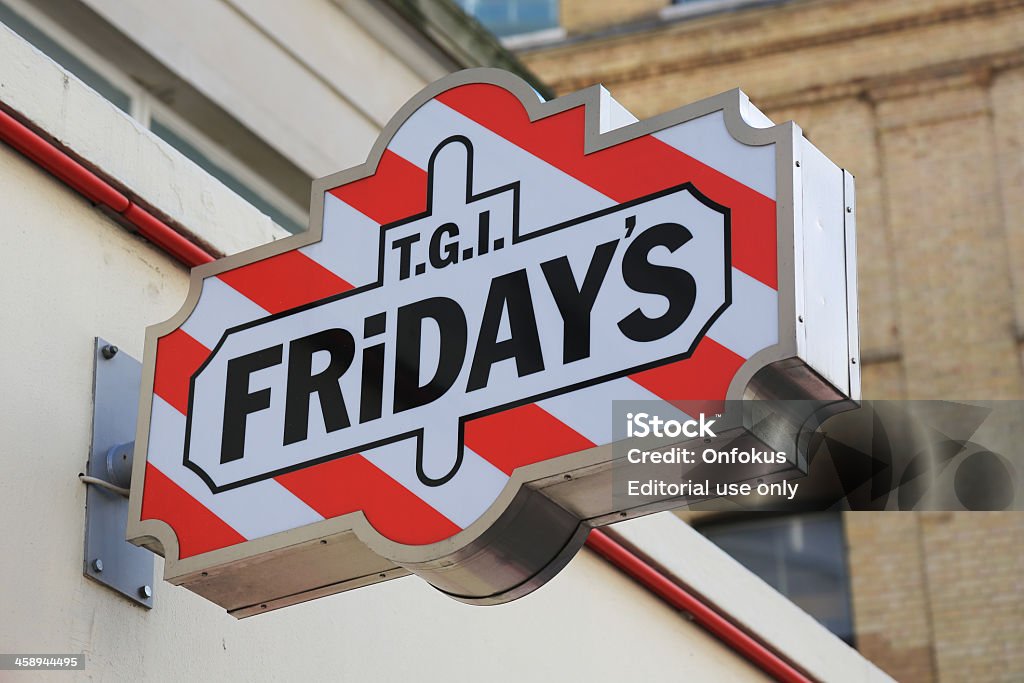 T.G.I. Fridays sign in London, Uk London, UK - April 15, 2012: T.G.I. Fridays is an American restaurant chain focusing on casual dining.  The Friday's restaurant chain was founded by Alan Stillman in 1965. TGIF Stock Photo