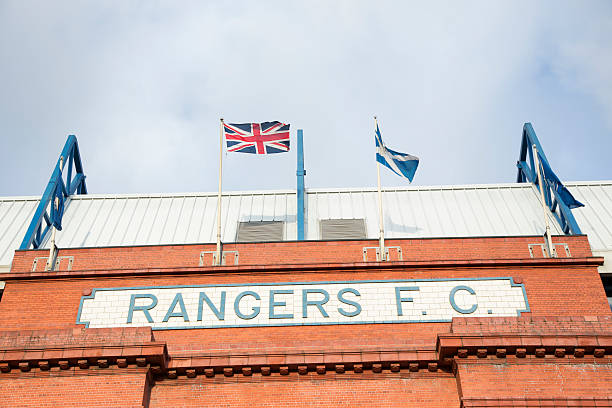 Ibrox Stadium, Glasgow "Glasgow, UK - December 7, 2012: The Union Flag and the Scottish Saltire fly above the Rangers F.C. sign over the Bill Struth Main Stand at Ibrox Stadium, Glasgow, the home ground of Rangers Football Club. The main stand was built in 1928 with an impressive red brick facade." ibrox stock pictures, royalty-free photos & images