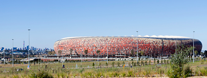 Johannesburg, South Africa - April,7th 2012: FNB Stadium or Soccer City, with Johannesburg city seen in the background. Built in the shape of a calabash for the 2010 FIFA World Cup and seats approximately 95000 people.