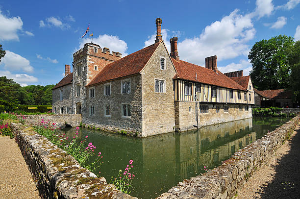 Ightham Mote "Ightham, England - May 21, 2011: This 14th century medieval moted house was refurbished by the National Trust. This view is from the south east corner and one of the three entrance bridges can be seen on the left." national trust photos stock pictures, royalty-free photos & images