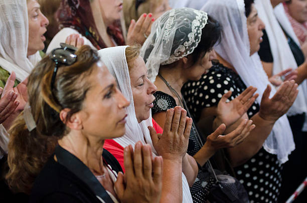 Erbil, Iraq - May 2, 2017: Iraqi Christians worship at the Mart Shmoni church, a Syriac Catholic church in Ankawa, a suburb of Erbil, Iraq. Most of the parisioners are IDPs, pushed out of their homes in Qaraqosh during the 2014 ISIS advance.