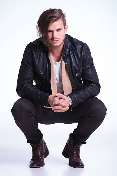 istock smiling young man in leather jacket standing crouched 458946019