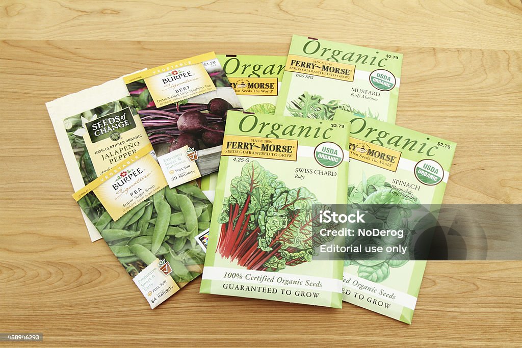 Vegetable seeds "West Palm Beach, USA - August 12, 2012: A group of various vegetable seed packets. Included are FerryMorse organic seeds for various vegetable greens, Burpee sugar snap peas and beet seeds, and Seeds of Change jalapeno pepper seeds." Packet Stock Photo