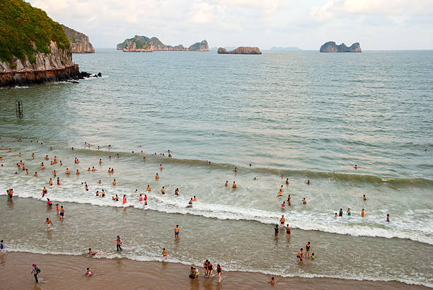 Cat Ba, Vietnam - July 21, 2007: Vietnamese enjoy the beach at sunset on Cat Ba Island in Halong Bay.