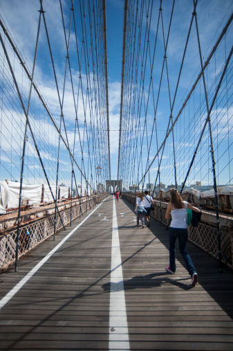 New York City, New York, United States - September 11th, 2012 - People walking across Brooklyn Bridge