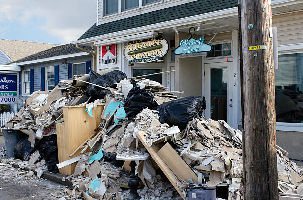 Retail Businesses Rebuild After Super Storm Sandy "Beach Haven, New Jersey, USA - December 1, 2012: Retail businesses in Beach Haven, Long Beach Island, New Jersey, gut their shops and put the debris out at the curb as they start the grueling task of recovery and rebuilding after Hurricane Sandy." superstorm stock pictures, royalty-free photos & images