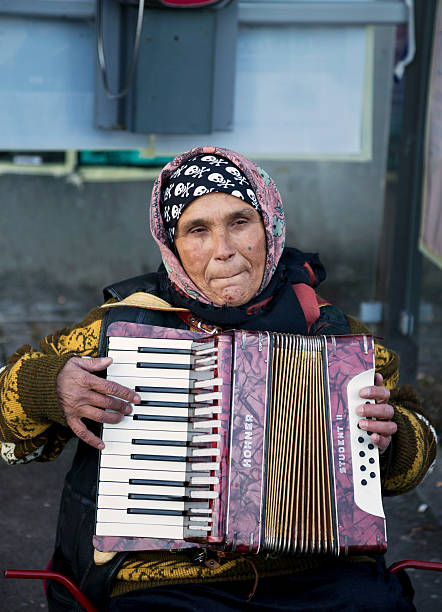 old beggar woman playing accordion. - dragspel ute sverige bildbanksfoton och bilder