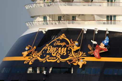 Cape Canveral, Florida, USA - November 1, 2012: The Cruise Ship Disney Dream heads to sea from Cape Canaveral. The ship features Mickey Mouse on the stern as a wizard.
