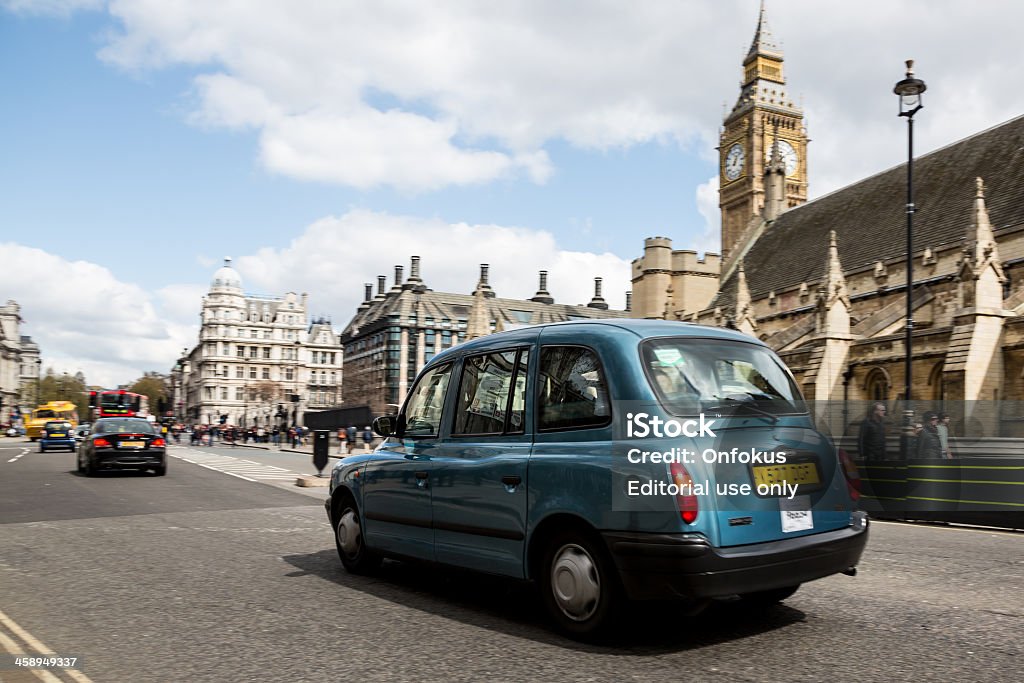 London Taxi Cab on Westminster Bridge, United Kingdom London, UK - April 15, 2012: London taxi cab on Westminster Bridge and people walking on the street.  Car Stock Photo