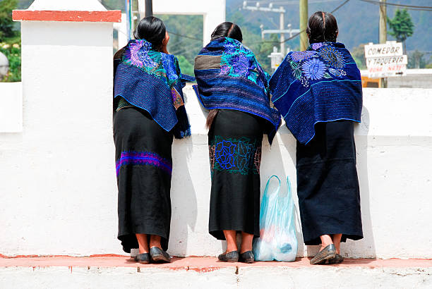 Huatajata, La Paz Province, Bolivia.  June 4th 2006.  Women leaving  an evangelical baptist church after a Sunday service on the day of Pentecost in the town of Huatajata on the shore of Lake Titicaca, Bolivia.