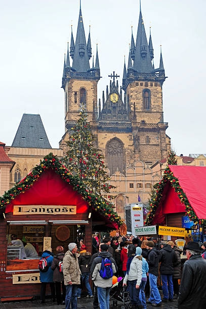 Old Town square "Prague,Czech Republic-December 30,2009: Tourist and local people on the Christmass market, on the Old Town Square. The markets consist of brightly decorated, wooden huts selling traditional handcrafted products such as wooden toys, Bohemian Crystal, ceramic plates....In background Church of Our Lady before TAn" prague christmas market stock pictures, royalty-free photos & images