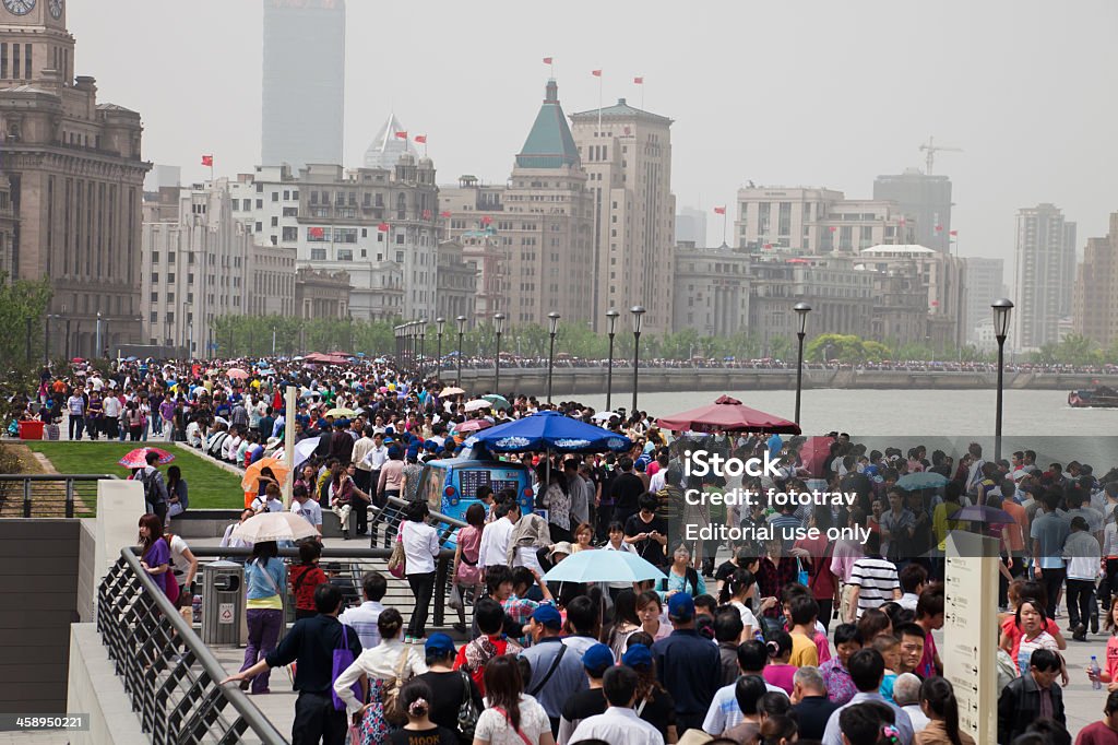 Chinese crowd, Shanghai, China Shanghai, China - May, 1 2011: Chinese tourists walking on Bund during the Chinese May 1st holiday, Shanghai, China. Pollution can be seen in the background Adults Only Stock Photo