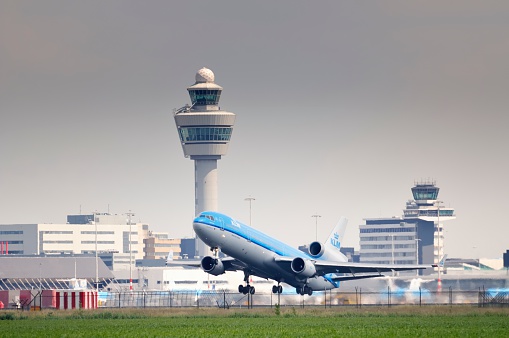 Schiphol, The Netherlands - June 12, 2011: KLM McDonnell Douglas MD-11 airplane taking off from Schiphol Airport.