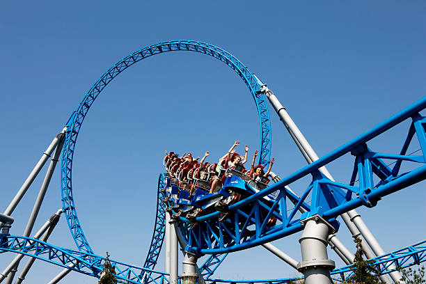 Rollercoaster "Rust, Germany - July 12, 2011: Visitors of the Europa - Park theme park enjoying their ride on the Blue Fire rollercoaster one of the latest attractions. The Europa - Park is the largest seasonal theme park in the world and is situated near the borders of Germany, France and Switzerland." rollercoaster photos stock pictures, royalty-free photos & images