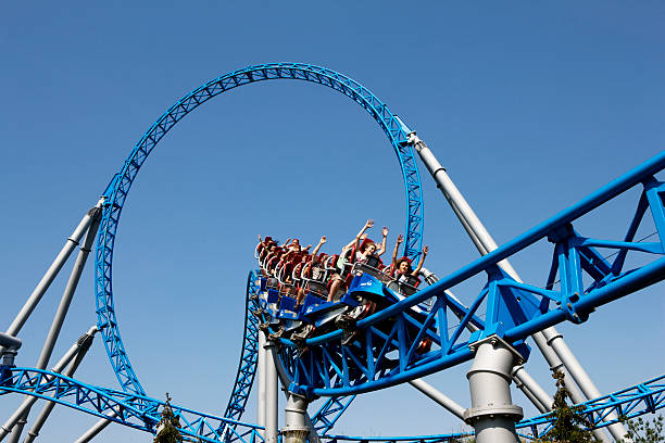 Rollercoaster "Rust, Germany - July 12, 2011: Visitors of the Europa - Park theme park enjoying their ride on the Blue Fire rollercoaster one of the latest attractions. The Europa - Park is the largest seasonal theme park in the world and is situated near the borders of Germany, France and Switzerland." rollercoaster stock pictures, royalty-free photos & images
